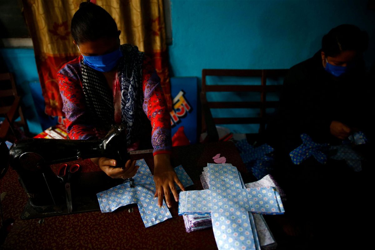 <i>Skanda Gautam/Zuma</i><br/>A volunteer stitches cloth to make reusable sanitary pads at Sinamangal in Kathmandu