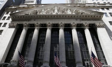 American flags hang outside of the New York Stock in the early afternoon at the NYSE on Wall Street in New York City on June 21. On July 6