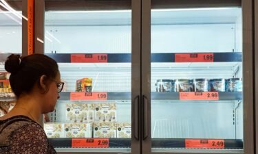 A customer looks at the depleted stock of ice cream at a Lidl supermarket. A dramatic surge in Covid-19 cases is forcing hundreds of thousands of workers to stay home in Britain
