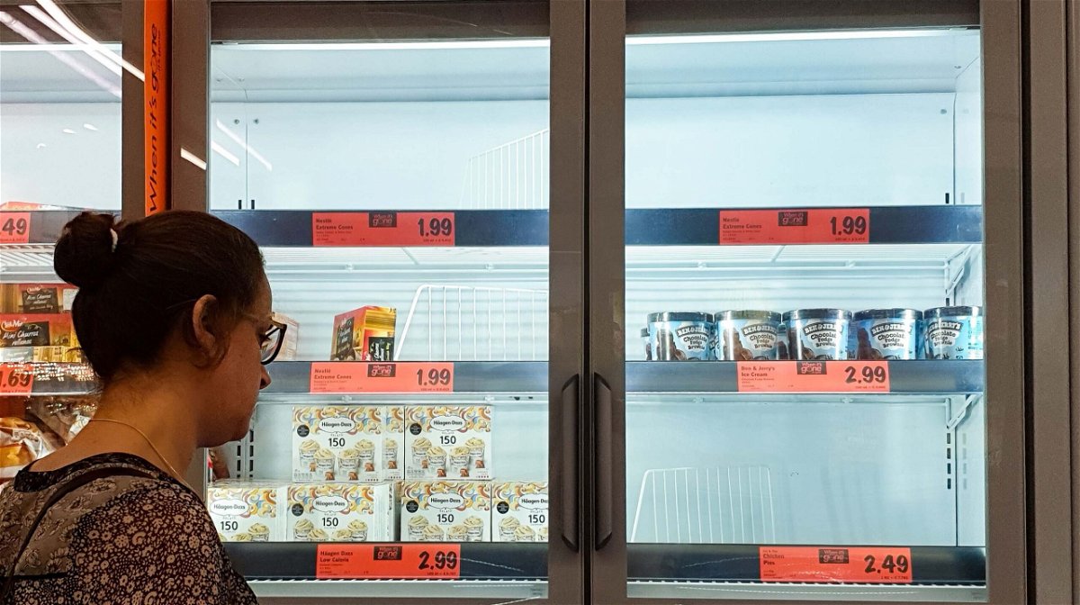 <i>Dinendra Haria/LNP/Shutterstock</i><br/>A customer looks at the depleted stock of ice cream at a Lidl supermarket. A dramatic surge in Covid-19 cases is forcing hundreds of thousands of workers to stay home in Britain