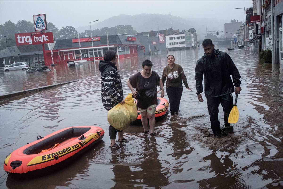 <i>Valentin Bianchi/AP</i><br/>Residents use rubber rafts to evacuate after the Meuse River broke its banks during heavy flooding in Liege