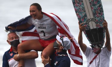 US's Carissa Moore celebrates after winning the women's Surfing gold medal final at the Tsurigasaki Surfing Beach