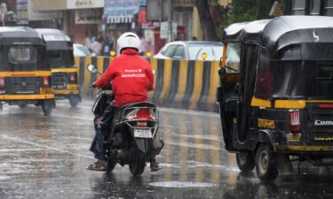 A Zomato delivery man is seen riding along the streets of Mumbai. Shares in Zomato gained about 80% on their first day of trading on Mumbai's stock exchange.