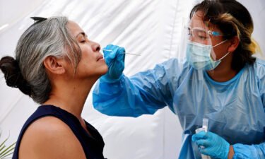 A medical assistant administers a Covid-19 test to a person at Sameday Testing on July 14 in Los Angeles. Covid-19 cases are on the rise in most states as the highly transmissible Delta variant has become the dominant strain in the United States.