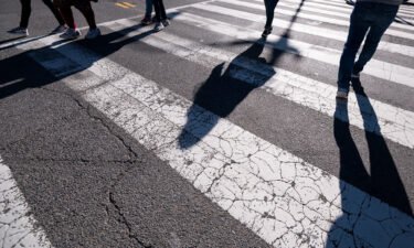 Pedestrians cross the street using a crosswalk in downtown Washington on Monday