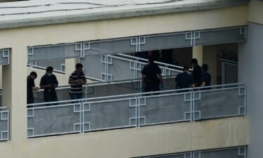 Police officers are seen along a corridor at River Valley High School in Singapore on July 19. A 16-year-old boy was due to be charged with murder by Singapore police after a 13-year-old boy was found dead with multiple wounds in a school bathroom along with an ax.