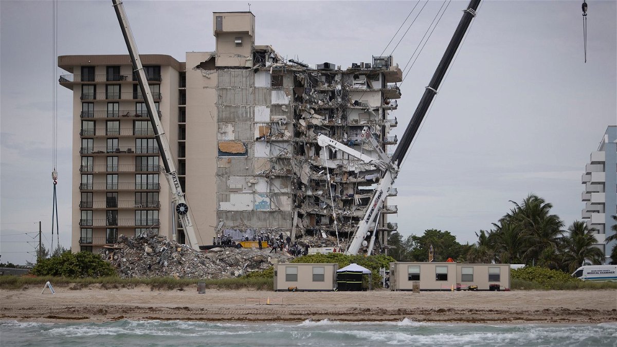 <i>Joe Raedle/Getty Images</i><br/>Search and rescue teams look for possible survivors in the partially collapsed 12-story Champlain Towers South condo building in Surfside