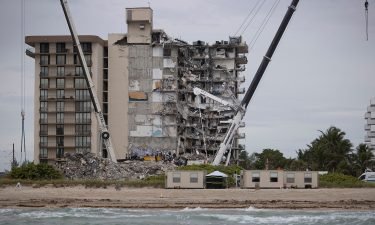 Search and rescue teams look for possible survivors in the partially collapsed 12-story Champlain Towers South condo building in Surfside