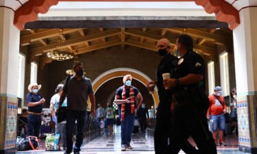 People wear face coverings at Union Station in Los Angeles on July 19. Despite now having a powerful tool to help suppress the spread of coronavirus -- three very effective vaccines -- the nation is once again seeing rising cases