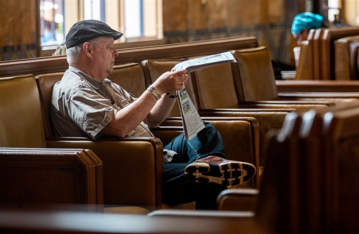 <i>Francine Orr/Los Angeles Times/Getty Images</i><br/>A new book argues that chasing subscription dollars is bad for journalism. A man reads a newspaper inside Union Station on June 29
