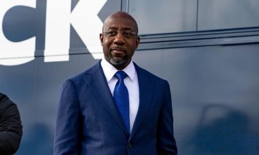 Georgia Democratic Candidate Rev. Raphael Warnock meets with supporters on January 5 in Marietta