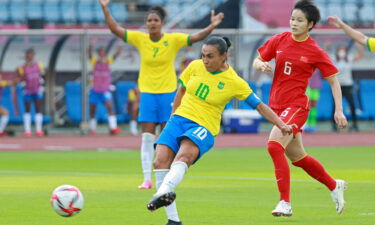 Brazil's midfielder Marta shoots to score the opening goal during the match against China.