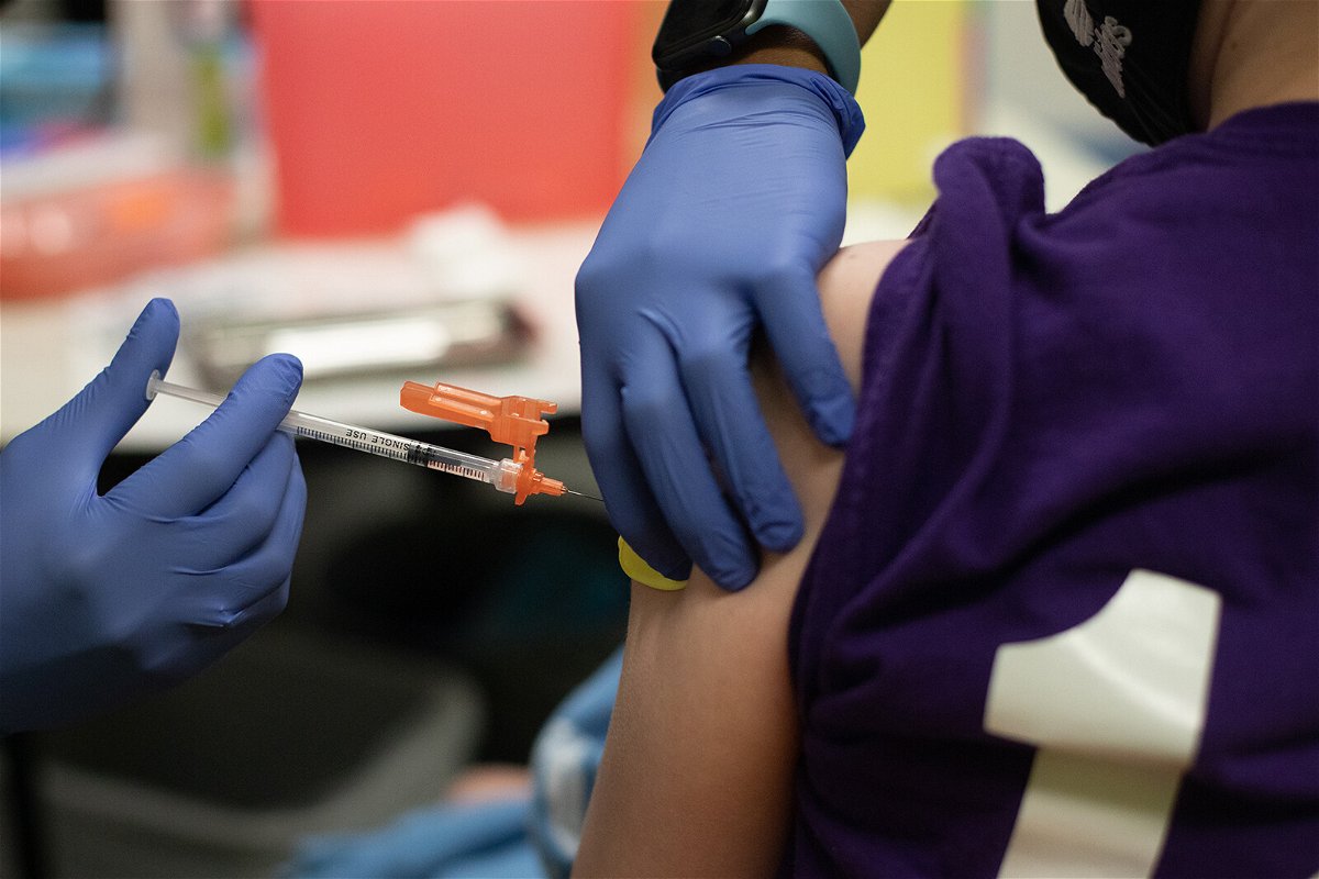 <i>Emily Elconin/Bloomberg/Getty Images</i><br/>A healthcare worker administers a dose of a Pfizer-BioNTech Covid-19 vaccine to a child at a pediatrician's office in Bingham Farms