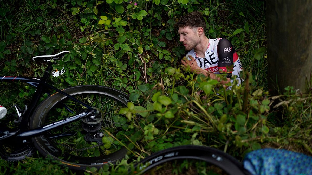 <i>Daniel Cole/AP</i><br/>Switzerland's Marc Hirschi lies on the side of the road after crashing in the Tour de France.