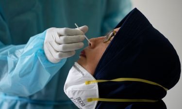 A woman has her nasal swab samples collected during mass testing for Covid-19 in Bekasi on the outskirts of Jakarta