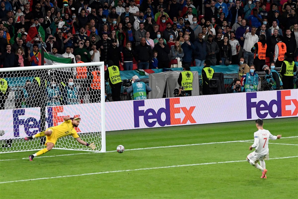 <i>Facundo Arrizabalaga/Pool/AP</i><br/>Italy's goalkeeper Gianluigi Donnarumma stops a penalty shot from Spain's Alvaro Morata during the semifinal match between Italy and Spain in London
