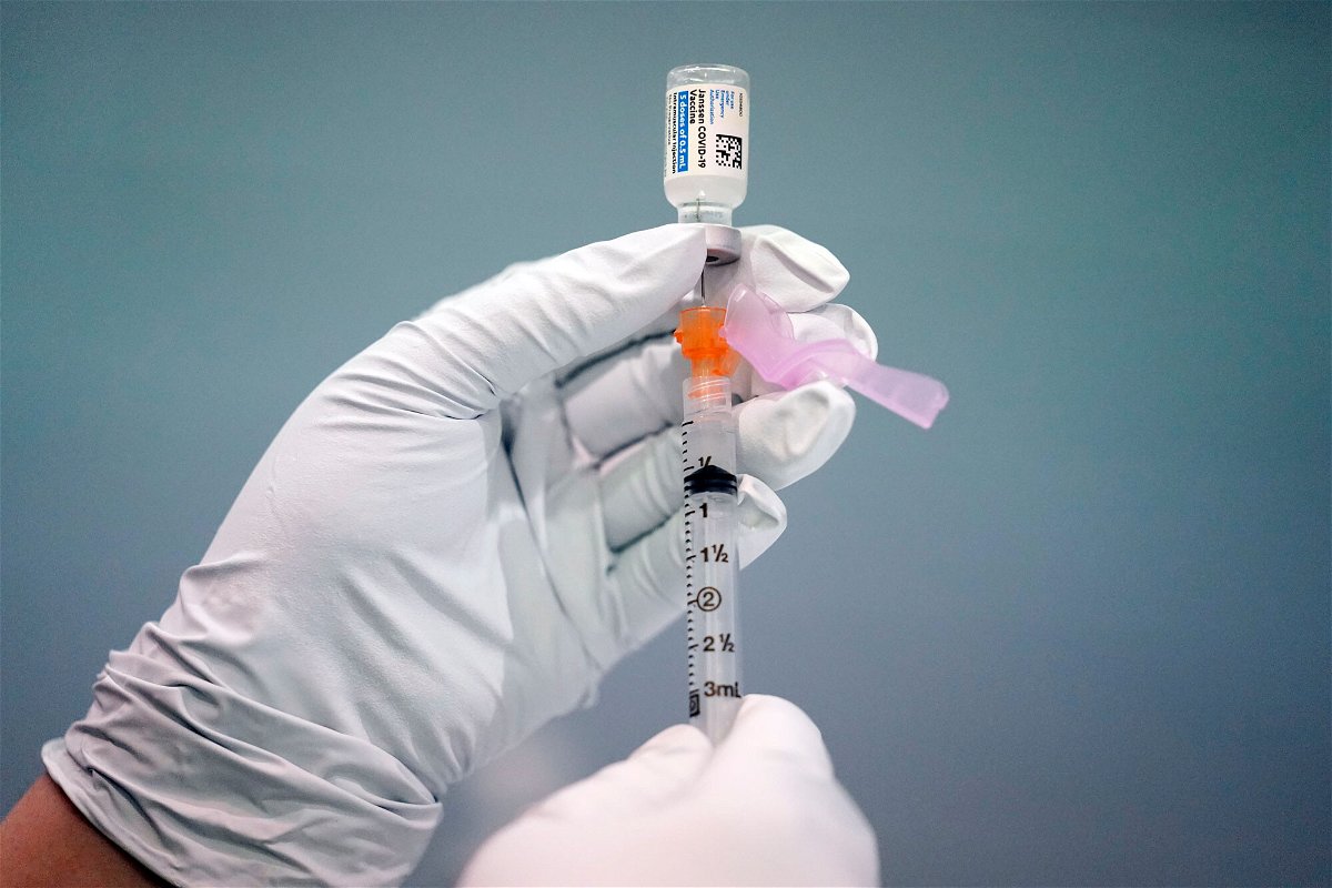 <i>Matt Rourke/AP</i><br/>A member of the Philadelphia Fire Department prepares a dose of the Johnson & Johnson COVID-19 vaccine at a vaccination site setup in Philadelphia on March 26. Covid-19 vaccination rates are down and cases are on the rise.