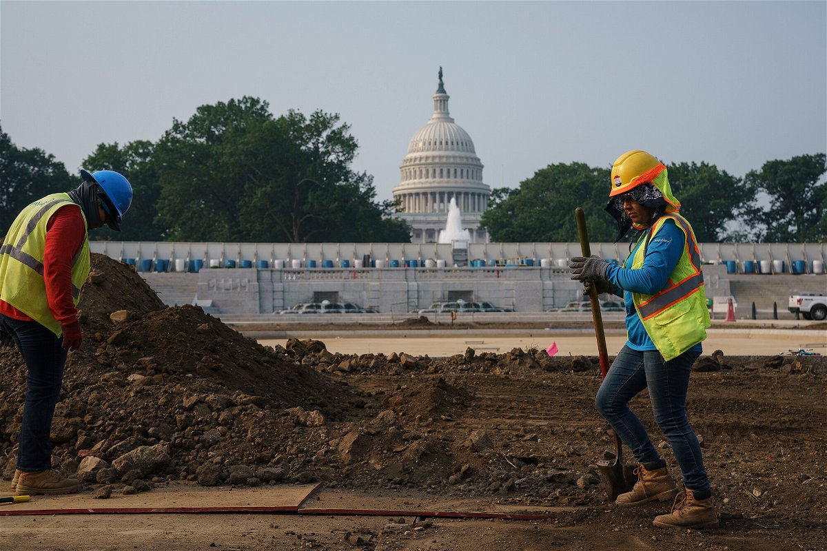 <i>J. Scott Applewhite/AP</i><br/>Workers repair a park near the Capitol in Washington on July 21 as senators struggle to reach a compromise over how to pay for nearly $1 trillion in public works spending
