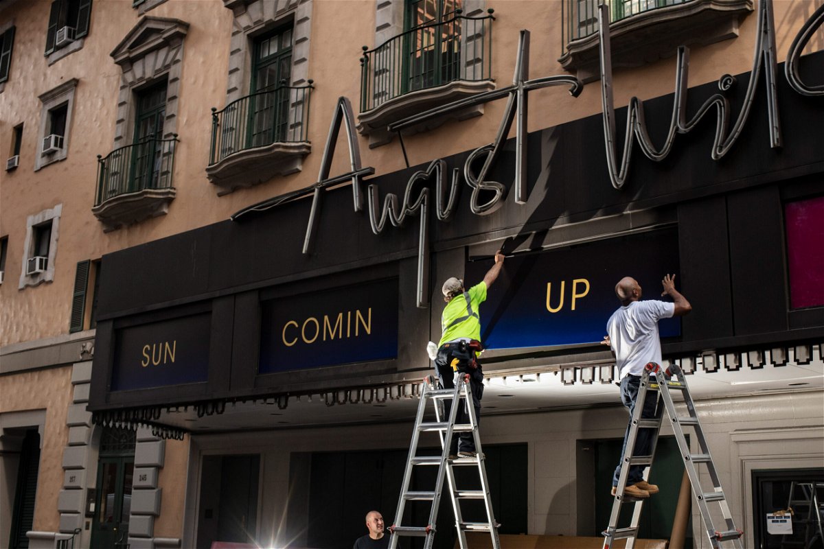 <i>Bryan Anselm/For The Washington Post/Getty Images</i><br/>Workers replace signs at the August Wilson Theatre in New York City on June 29. More than a year into a global pandemic and amid an international social justice movement