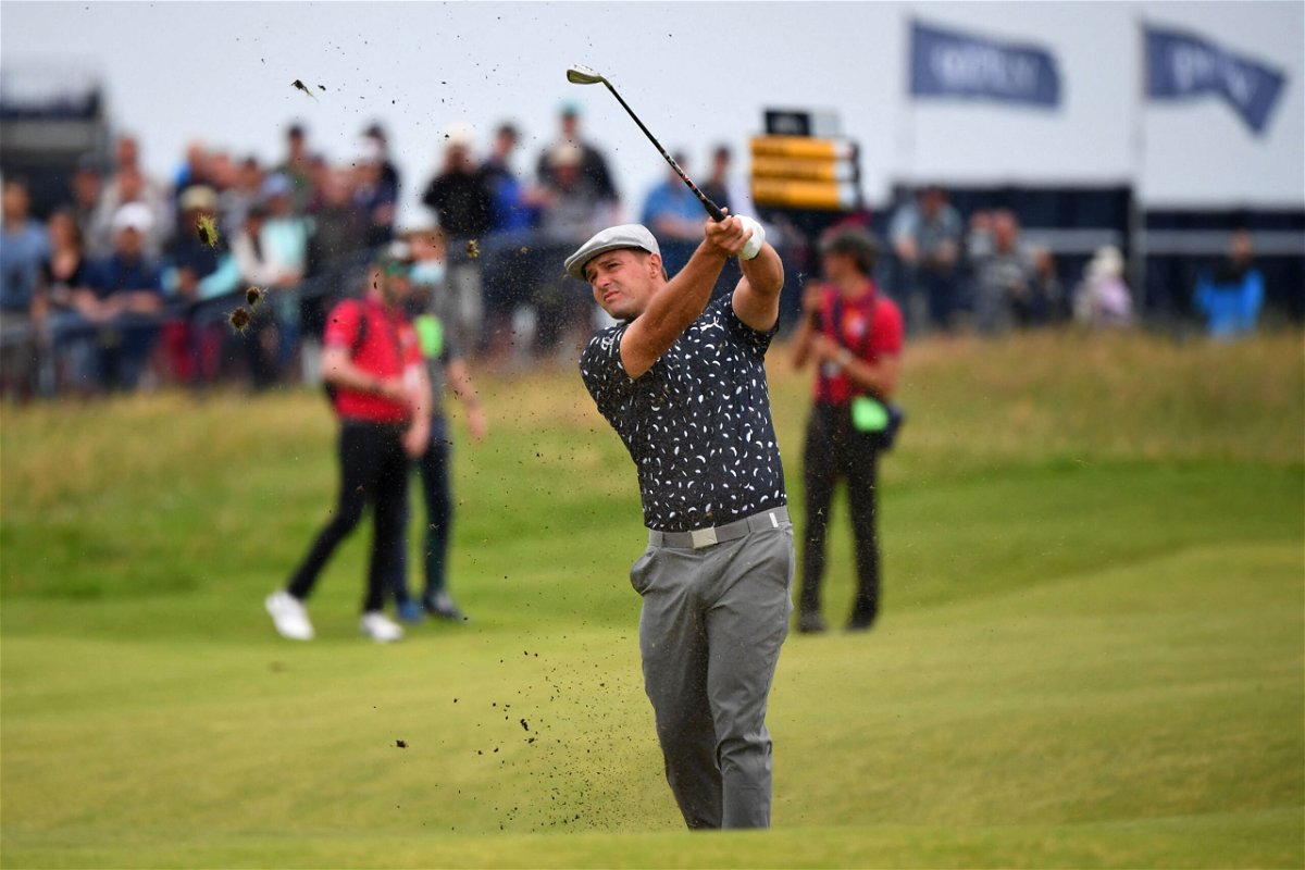 <i>Andy Buchanan/AFP/Getty Images</i><br/>DeChambeau plays his approach shot from the 18th fairway during his first round of The Open.