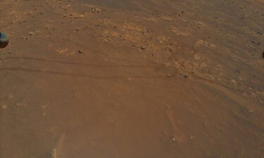 The Ingenuity helicopter is flying in parallel with the Perseverance rover as it drives on Mars -- as shown by the rover tracks captured by the chopper's camera on July 5.