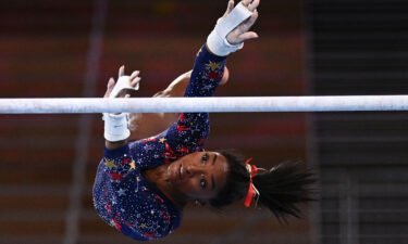 USA's Simone Biles competes in the uneven bars event of the  artistic gymnastics women's qualification during the Tokyo 2020 Olympic Games at the Ariake Gymnastics Centre in Tokyo on July 25.
