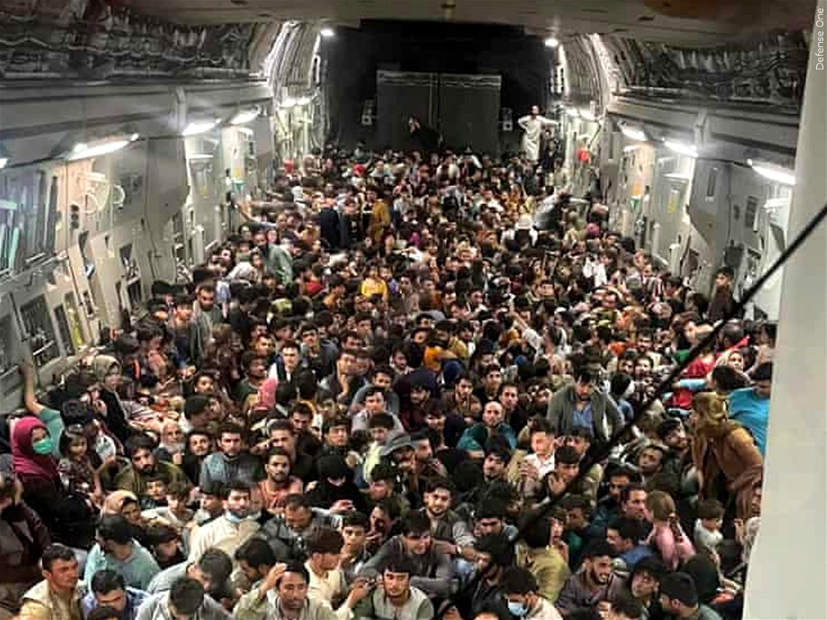 Afghans crowd into a U.S. military cargo plane after the fall of Kabul on Aug. 15, 2021.