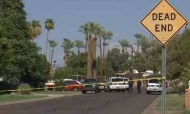 Police block off an area of Phoenix after they found three people dead in a home on August 8.