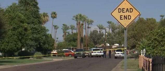 <i>KPHO KTVK</i><br/>Police block off an area of Phoenix after they found three people dead in a home on August 8.