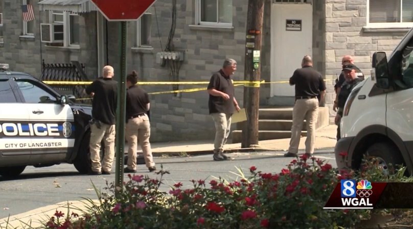 <i>WGAL</i><br/>Investigators survey the scene after a human head was found in a freezer in Lancaster