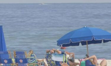 People relax at Gulf Shores in Alabama despite the threat of storm in the area.