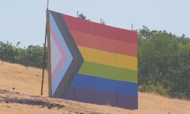 A giant pride flag was constructed on a farm less than two miles from Newberg High School following a school board vote to ban that type of sign