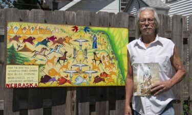 Omaha artist Donel Keeler poses with his artwork in 2019. Keeler created Nebraska's First People license plate.