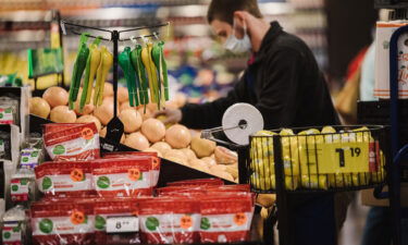 Shares of Kroger are up nearly 50% this year and trading at an all-time high. A Kroger worker here restocks produce in Versailles