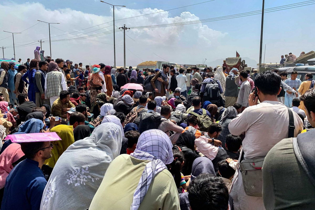 <i>Wakil Kohsar/AFP/Getty Images</i><br/>Afghan people wait to board a U S military aircraft to leave the country