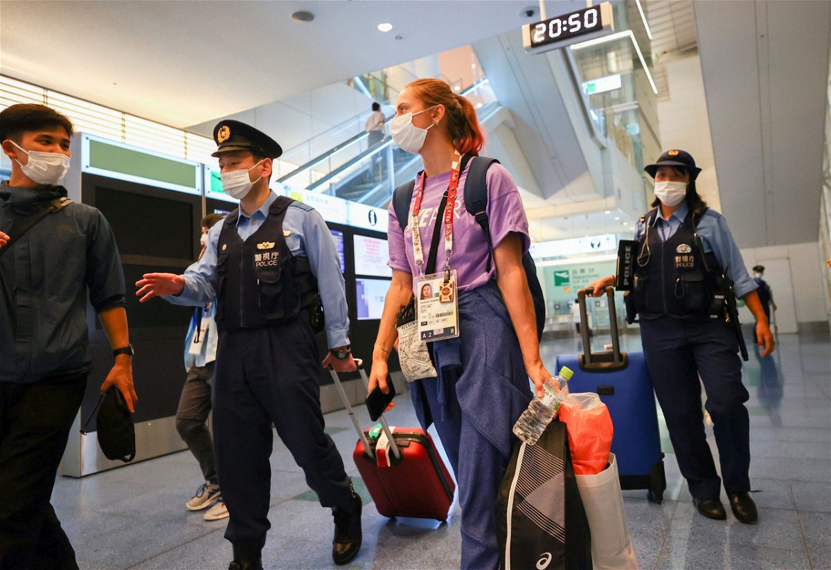 <i>Issei Kato/Reuters</i><br/>Kristina Timanovskaya is escorted by police officers at Haneda international airport in Tokyo