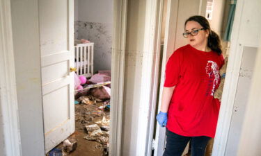 Vanessa Yates checks the damage inside of her home in Waverly following the flood.
