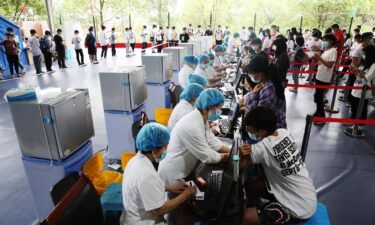 Doctors give Covid-19 vaccine to high school seniors at a temporary vaccination site in Chongqing