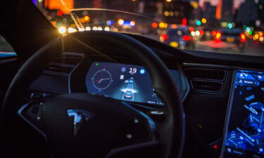 An instrument panel with the Tesla Motors Inc. 8.0 software update illustrates the road ahead using radar technology inside a Model S P90D vehicle.