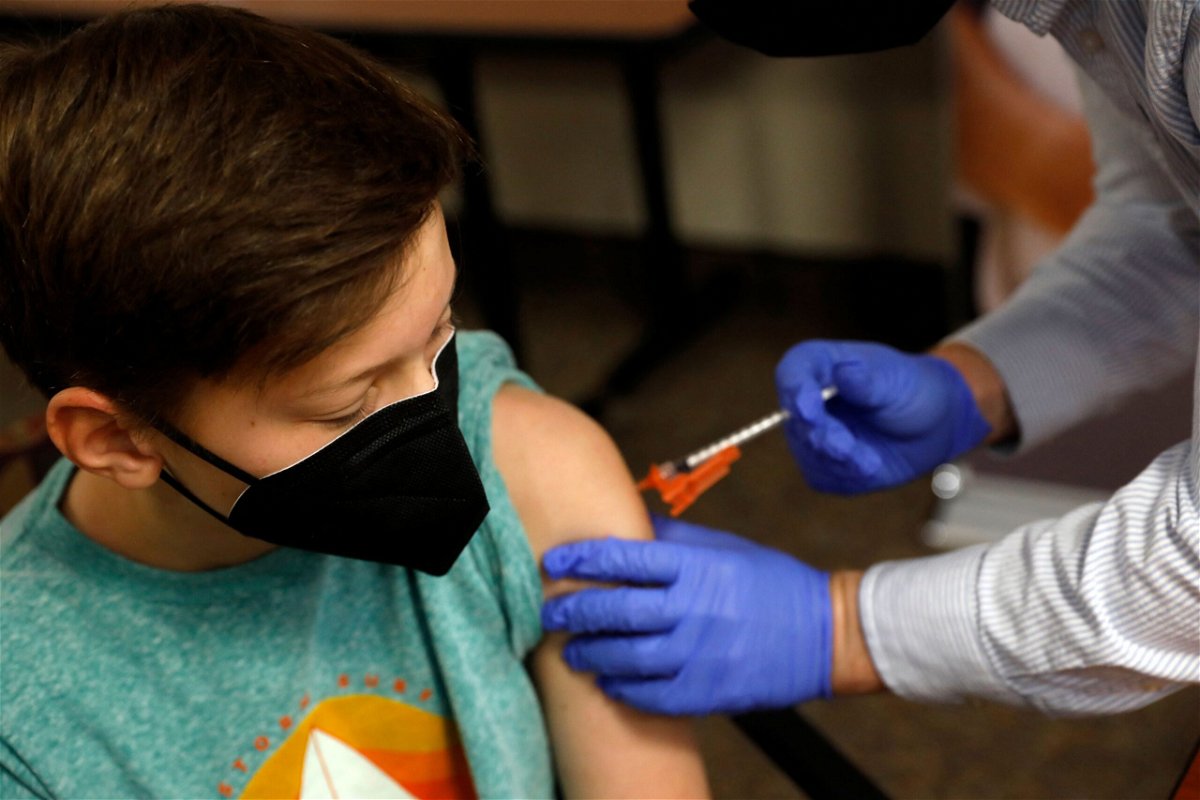 <i>Jeff Kowalsky/AFP via Getty Images</i><br/>Aiden Arthurs receives the Covid-19 Vaccine in Bloomfield Hills