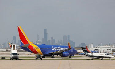 Southwest Airlines will cut the number of flights it operates this fall. Pictured is a Southwest Airlines jet taxiing at Midway International Airport in Chicago