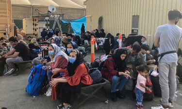 People wait to be evacuated from Afghanistan at the airport in Kabul on August 18