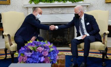 President Joe Biden shakes hands with Israeli Prime Minister Naftali Bennett as they meet in the Oval Office of the White House