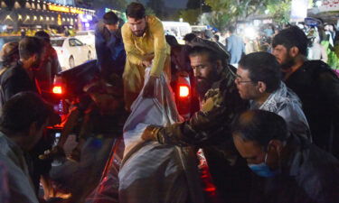 Volunteers and medical staff unload bodies from a pickup truck outside a hospital after the explosion outside the airport in Kabul on August 26.