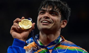 Gold medallist India's Neeraj Chopra celebrates on the podium during the victory ceremony for the men's javelin throw event during the Tokyo 2020 Olympic Games at the Olympic Stadium in Tokyo on August 7.