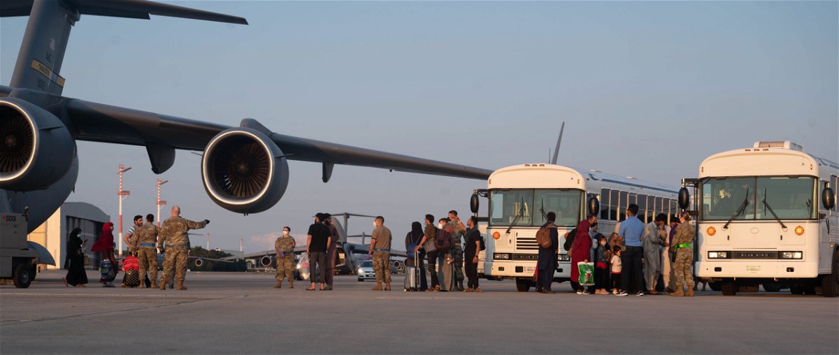 <i>Senior Airman Taylor Slater/86th Airlift Wing/US Air Force</i><br/>A group of Afghan evacuees depart a C-17 Globemaster III aircraft at Ramstein Air Base