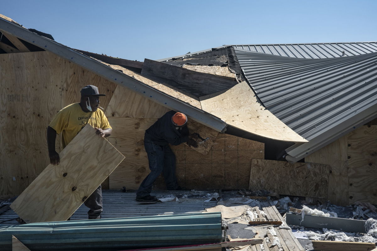 <i>Go Nakamura/Getty Images</i><br/>People work to seal the openings of a damaged bar in Lake Charles