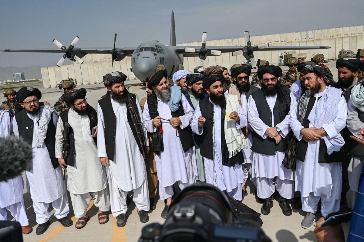 <i>Wakil Kohsar/AFP/Getty Images</i><br/>Taliban spokesman Zabihullah Mujahid speaks to the media at the Kabul airport.