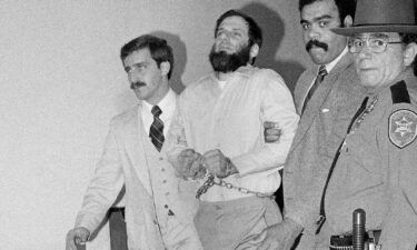 Outgoing New York Governor Andrew Cuomo commuted the sentence of the San Francisco District Attorney Chesa Boudin's father on Monday evening. A handcuffed David Gilbert is seen here in 1981 after a hearing in his felony murder case.