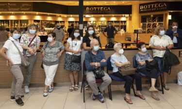 Members of the Naldi family wait to meet Adler at Bologna's airport.